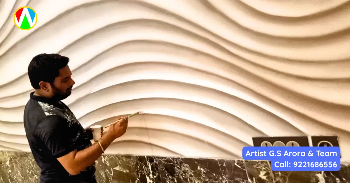 Artist hand-painting deep shadows into the curves of a 3D wave texture wall mural