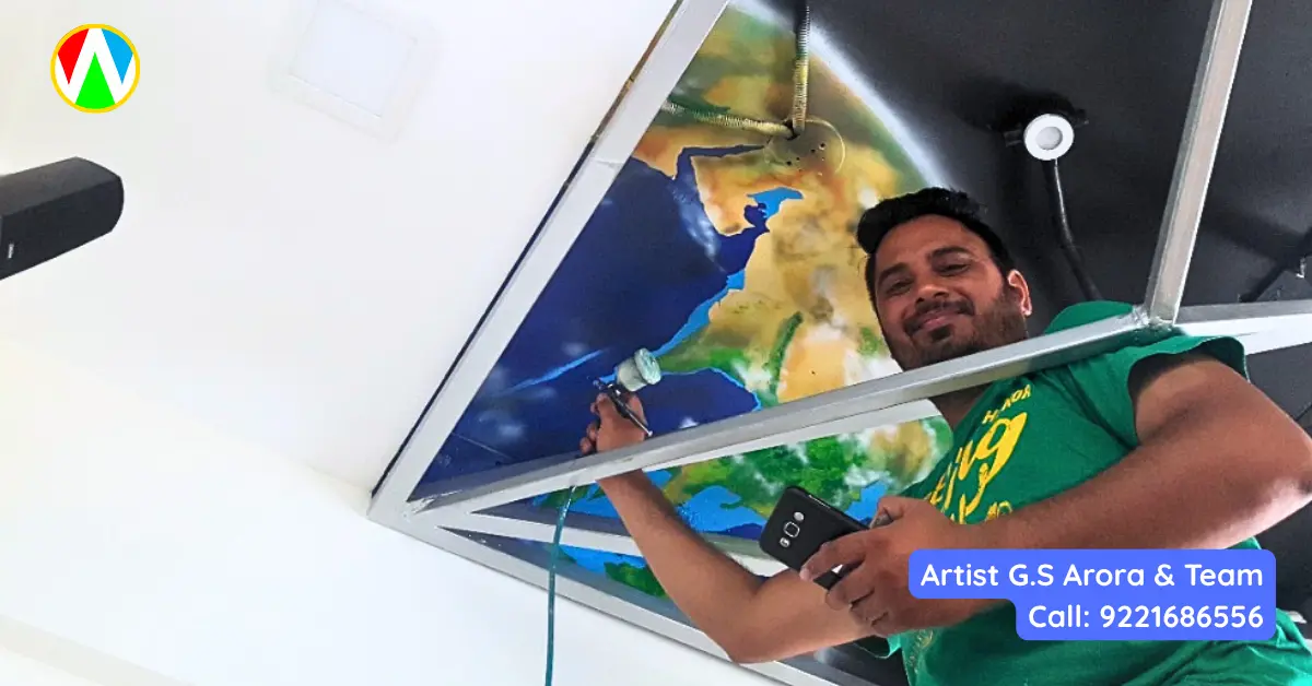 Artist G.S. Arora smiling while using an airbrush tool to paint a realistic Earth on an incredible 3D space ceiling mural