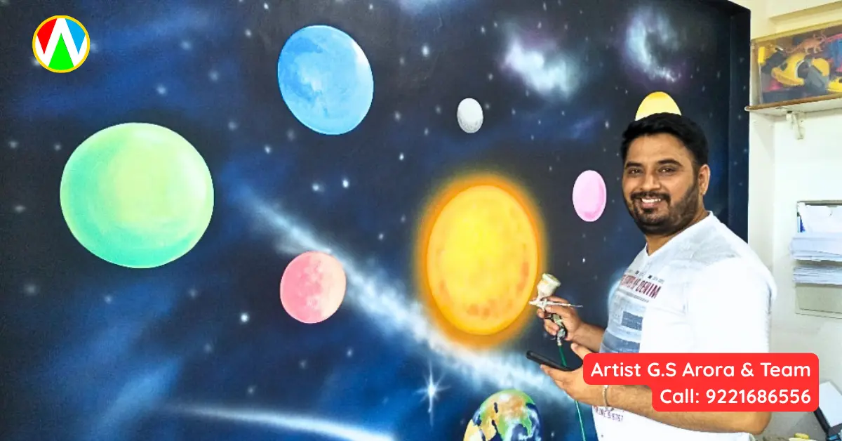 Artist using airbrush tool on space theme wall painting