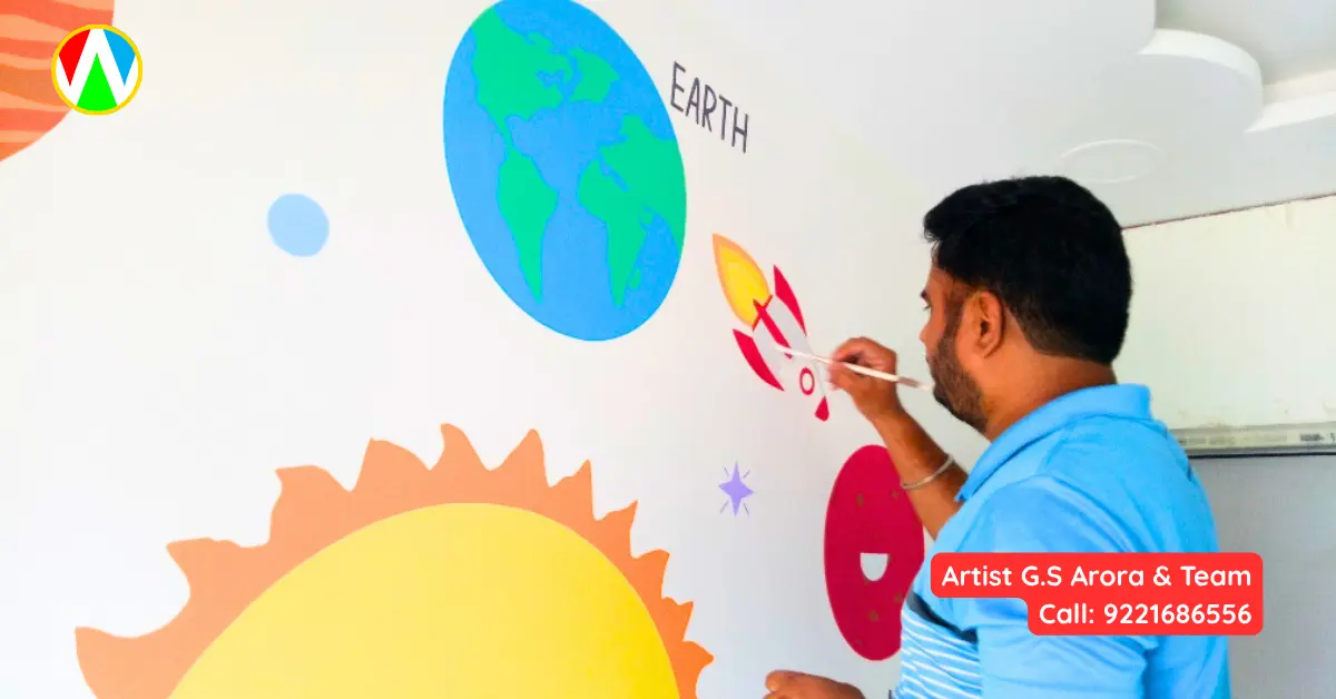 Artist carefully painting a red rocket ship on the solar system kids mural