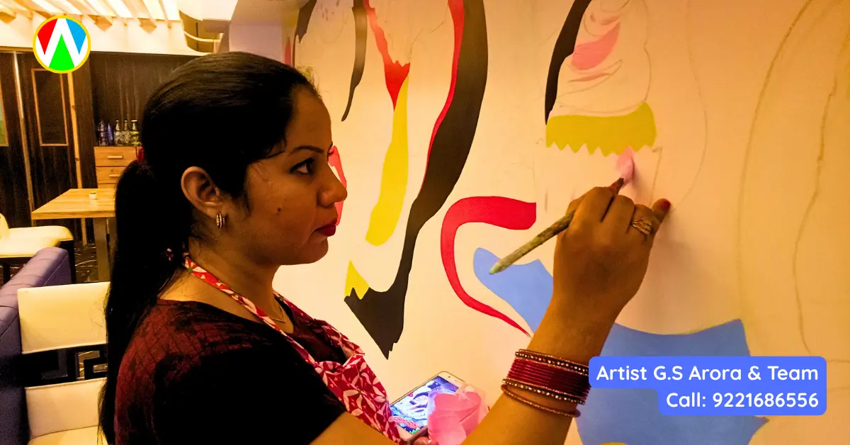 Female artist carefully hand-painting a cupcake detail on a massive restaurant graffiti mural